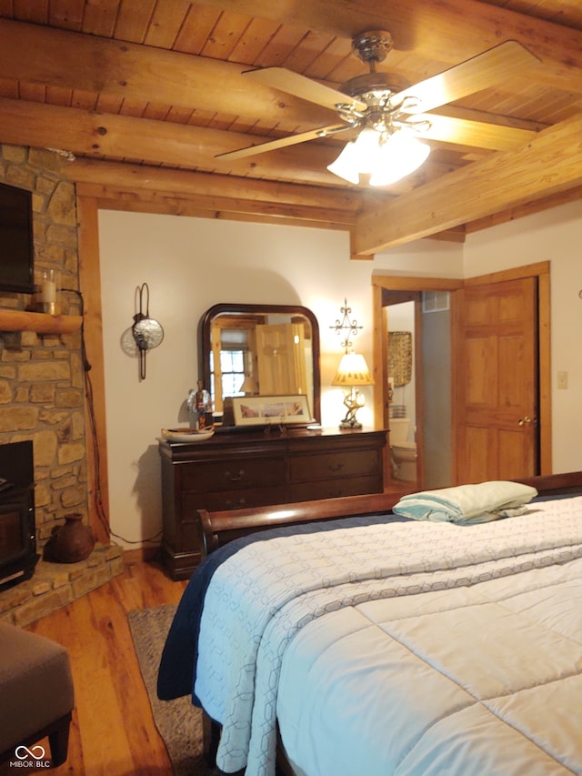 bedroom featuring beam ceiling, wooden ceiling, wood-type flooring, and ceiling fan