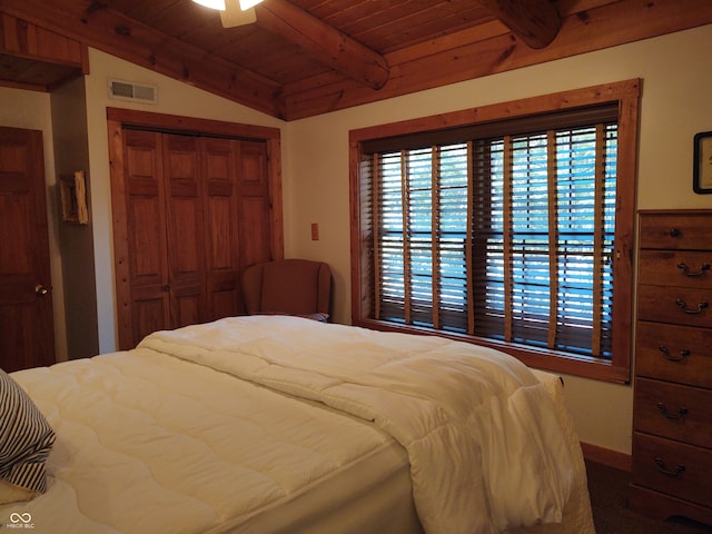 bedroom with a closet, ceiling fan, wooden ceiling, and vaulted ceiling with beams