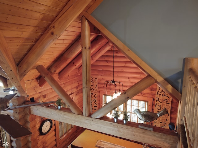 interior details featuring rustic walls, an inviting chandelier, and wood ceiling