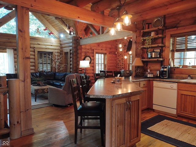 kitchen with a wealth of natural light, white dishwasher, log walls, and pendant lighting