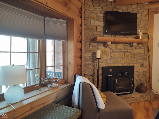 living room featuring a wood stove and hardwood / wood-style floors