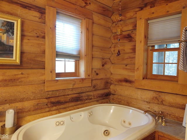 bathroom with a bathing tub and log walls