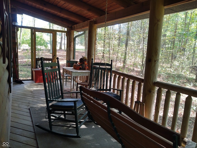 sunroom with vaulted ceiling with beams and wooden ceiling