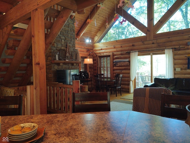 dining space with log walls, beamed ceiling, high vaulted ceiling, and wooden ceiling