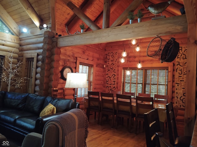 dining area with hardwood / wood-style flooring, beamed ceiling, wooden ceiling, rustic walls, and high vaulted ceiling