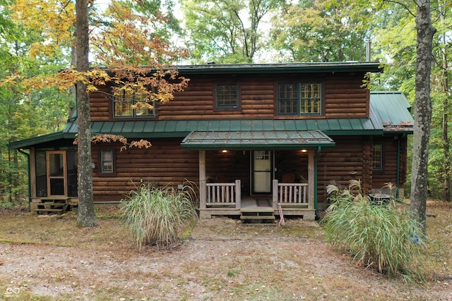 log cabin featuring covered porch