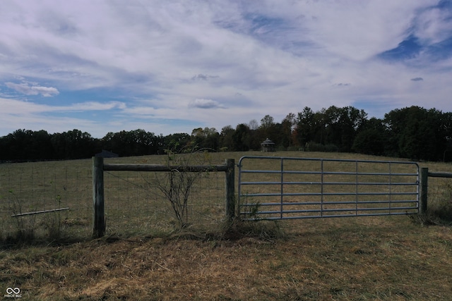 view of gate with a rural view