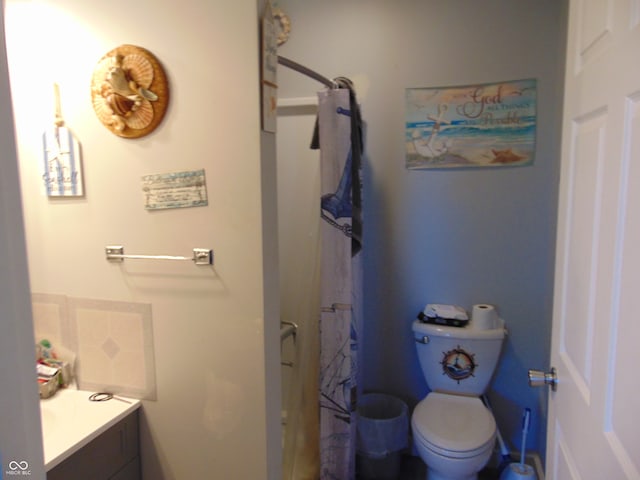 bathroom featuring walk in shower, vanity, and toilet