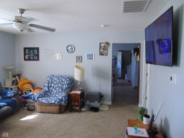 carpeted living room with ceiling fan