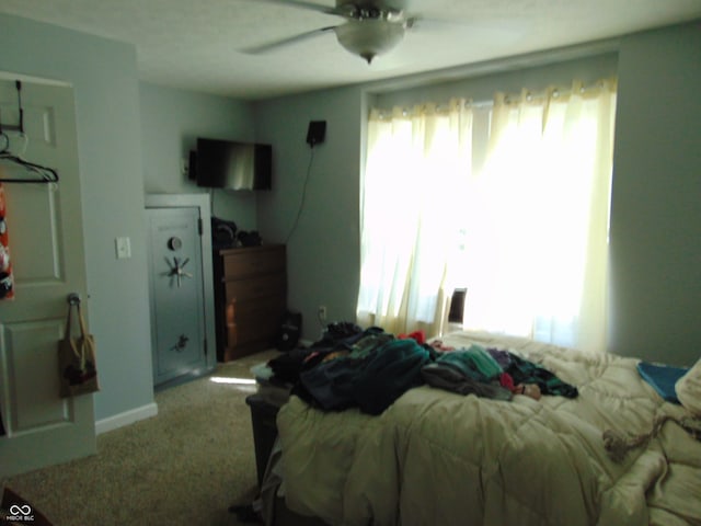 bedroom featuring light carpet and ceiling fan