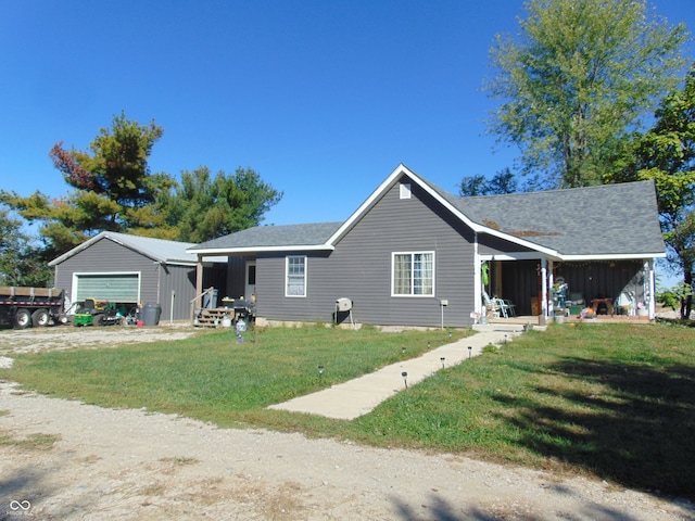 ranch-style house with an outbuilding, a garage, and a front yard