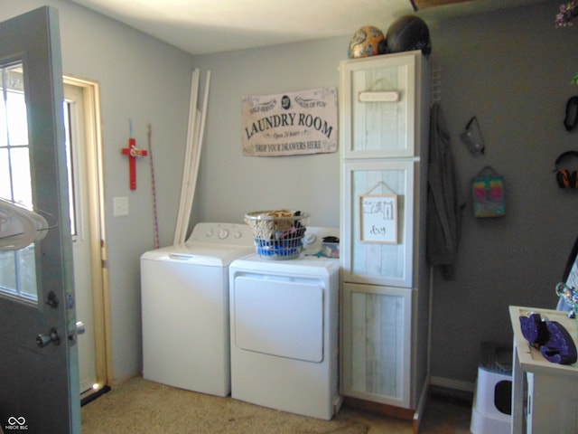 clothes washing area with washer and clothes dryer