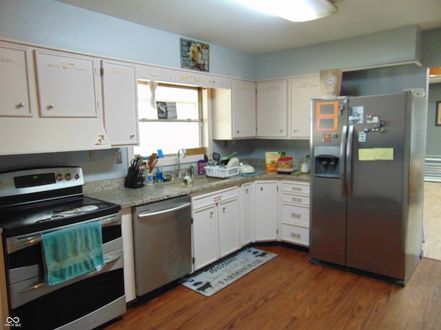 kitchen featuring light stone counters, white cabinets, sink, dark wood-type flooring, and stainless steel appliances