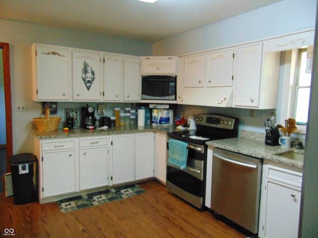 kitchen featuring light stone counters, dark hardwood / wood-style flooring, stainless steel appliances, and white cabinets