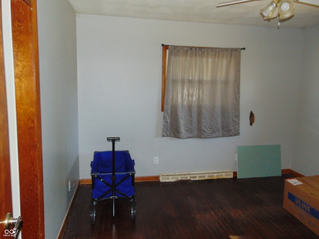 miscellaneous room with ceiling fan, a baseboard radiator, and dark hardwood / wood-style flooring