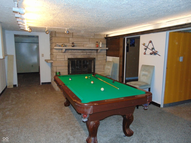 playroom featuring a textured ceiling, carpet floors, and a fireplace