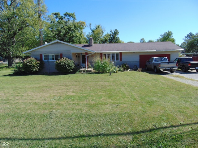 ranch-style house featuring a front lawn and a garage