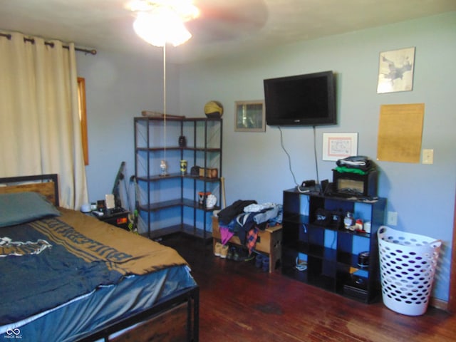 bedroom with dark hardwood / wood-style flooring