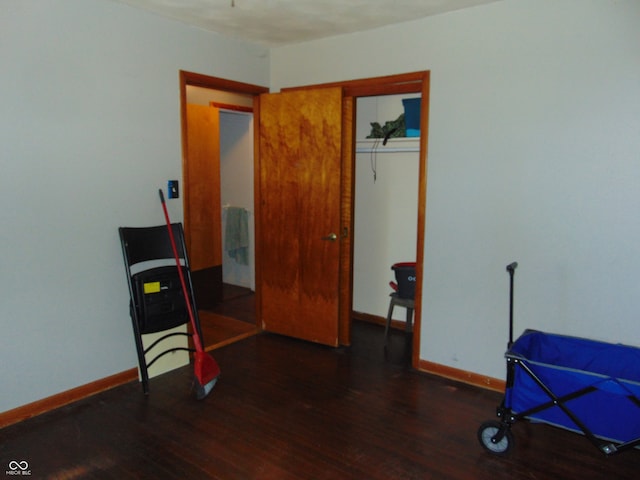 miscellaneous room featuring dark wood-type flooring