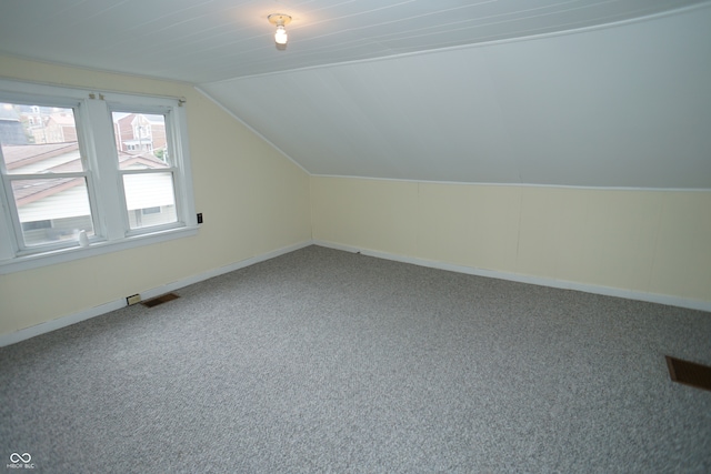 bonus room with lofted ceiling and carpet floors