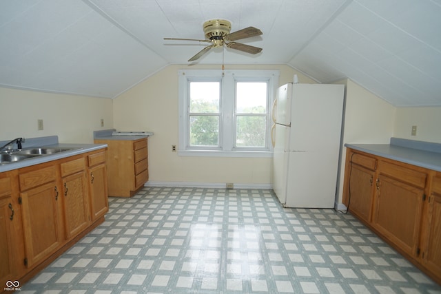 kitchen with ceiling fan, vaulted ceiling, white refrigerator, and sink