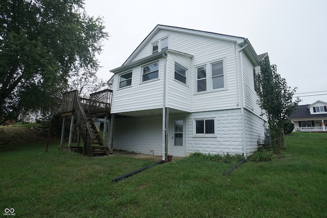 rear view of property with a deck and a yard