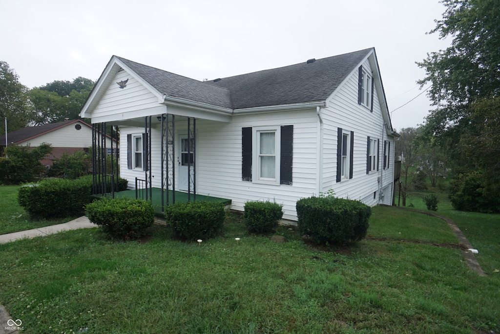 view of front of house with a front yard and a porch