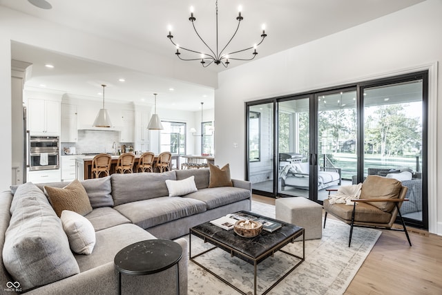 living room featuring light hardwood / wood-style flooring and a chandelier