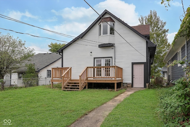 back of house featuring a wooden deck and a yard