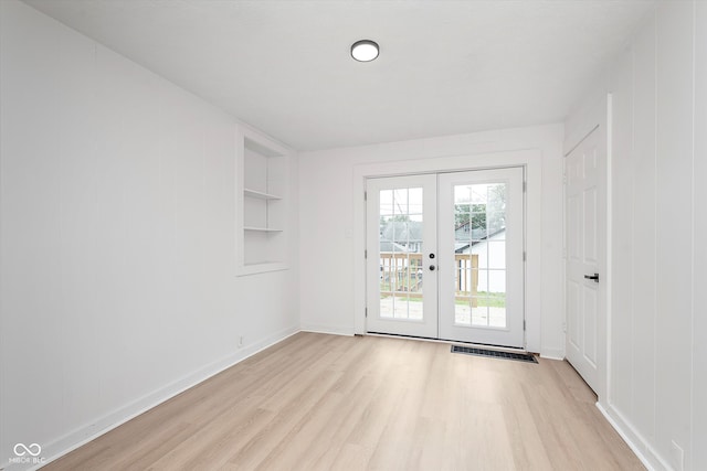 entryway featuring light hardwood / wood-style flooring, french doors, and built in features