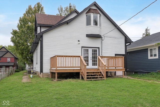 back of house featuring a lawn and a deck