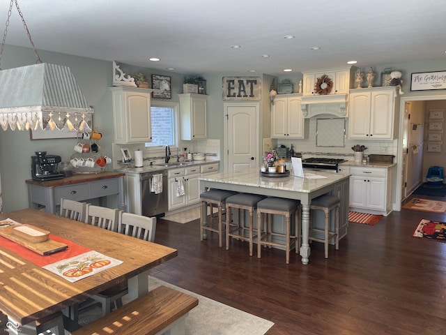 kitchen with white cabinetry, a center island, dark wood-type flooring, and sink