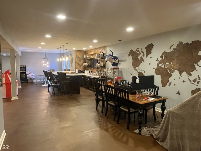 dining space featuring concrete floors and indoor bar