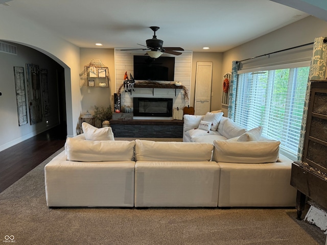 living room featuring wood-type flooring and ceiling fan