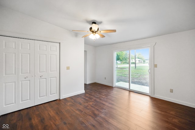 unfurnished bedroom featuring a closet, dark wood-type flooring, vaulted ceiling, access to outside, and ceiling fan