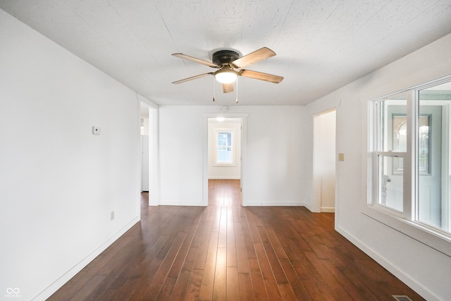 unfurnished room featuring ceiling fan and dark hardwood / wood-style flooring