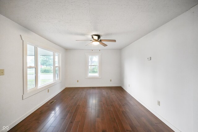 empty room featuring ceiling fan and dark hardwood / wood-style floors