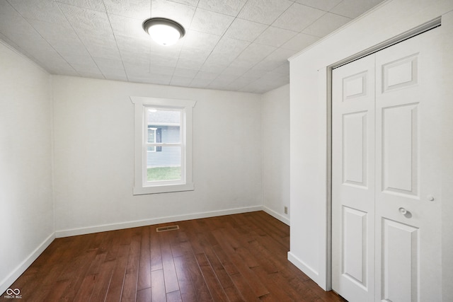 spare room with dark hardwood / wood-style flooring