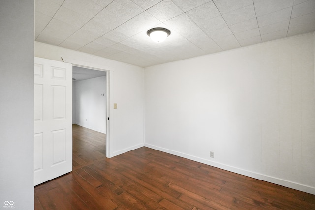 spare room with dark hardwood / wood-style floors