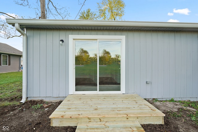 view of exterior entry featuring a wooden deck