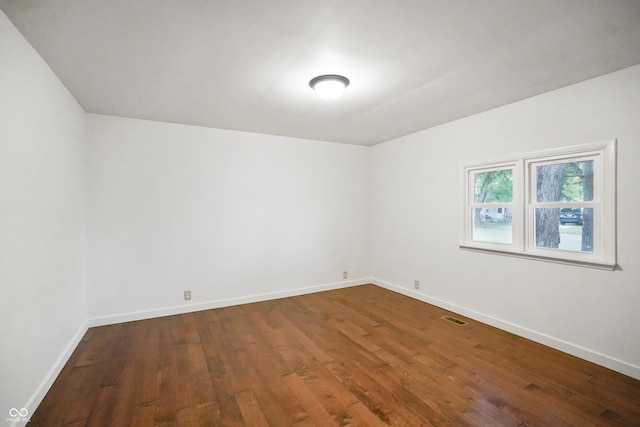 empty room with hardwood / wood-style flooring