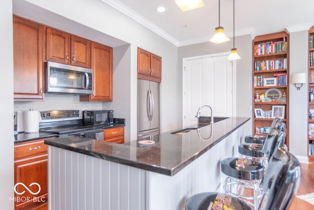 kitchen with black appliances, a center island with sink, hanging light fixtures, and sink