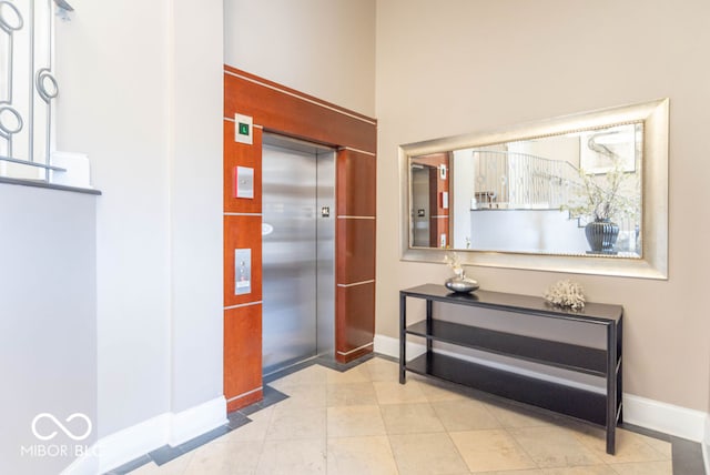 corridor featuring light tile patterned floors and elevator