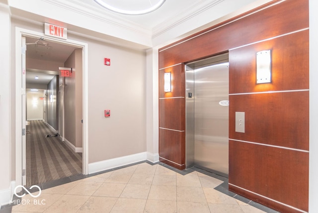 hall featuring ornamental molding, light tile patterned floors, and elevator