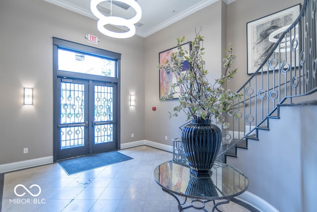 foyer entrance with french doors and ornamental molding