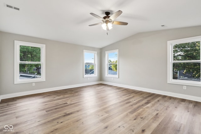 spare room with lofted ceiling, ceiling fan, and hardwood / wood-style flooring