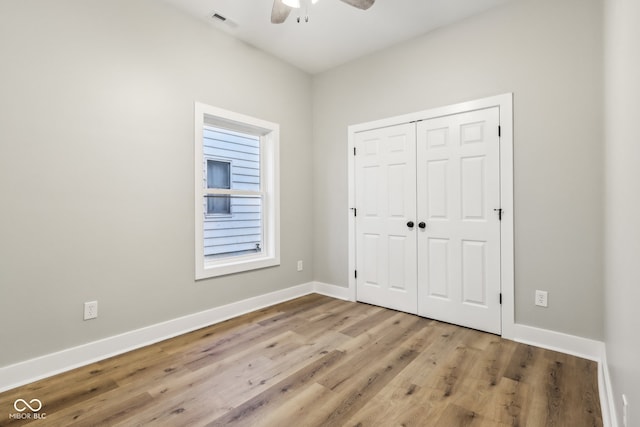 unfurnished bedroom with ceiling fan, a closet, and light hardwood / wood-style flooring