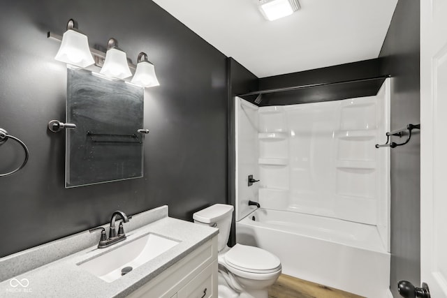 full bathroom featuring bathtub / shower combination, wood-type flooring, vanity, and toilet