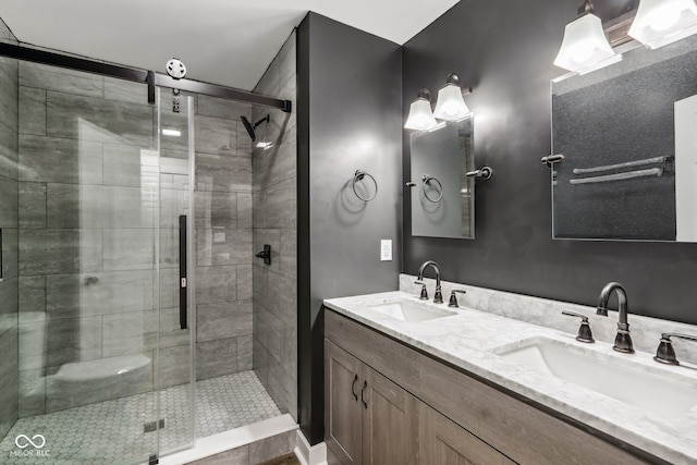 bathroom with a shower with door and vanity