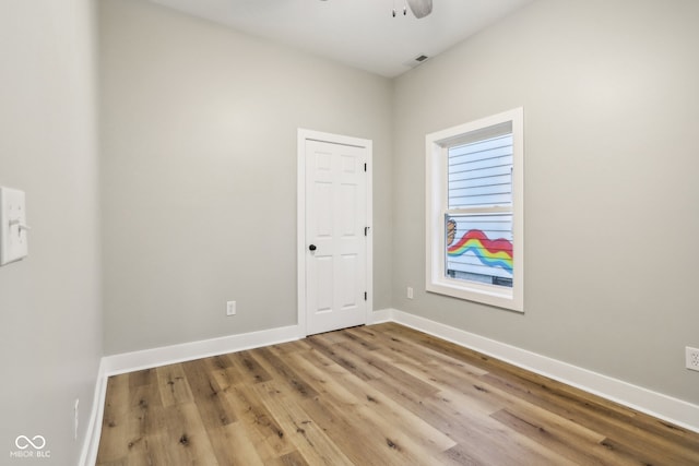 unfurnished room with light wood-type flooring and ceiling fan